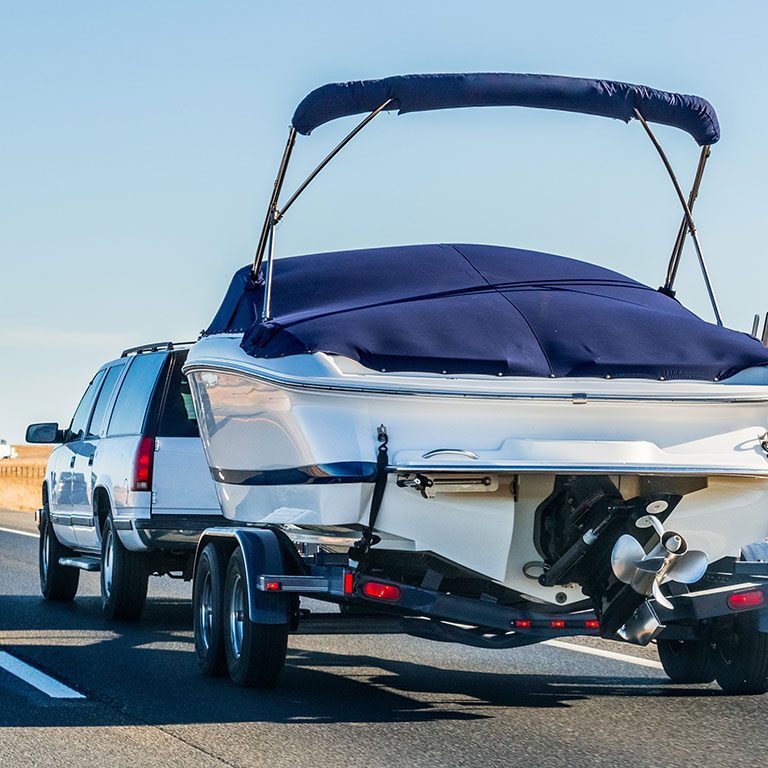 Boat Being Towed By Suburban